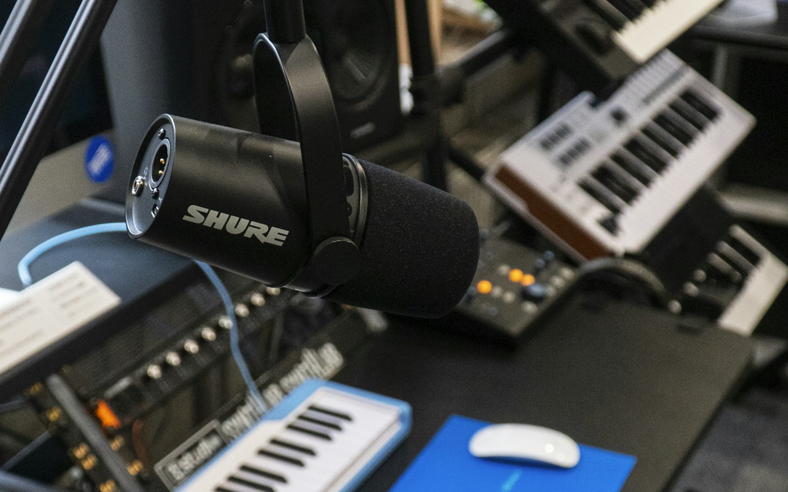 Microphone, keyboard, and computer in a recording studio