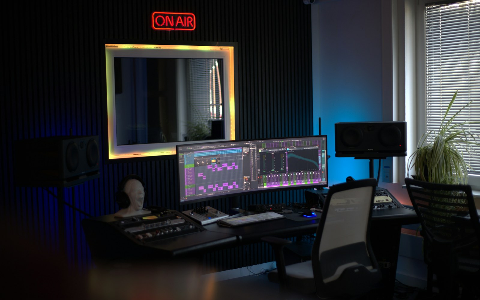 Audio production studio with monitors and an on-air light